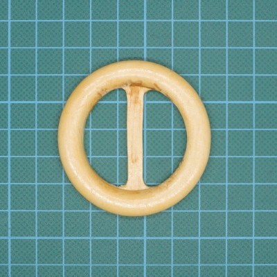 Argola circular em madeira clara com barra central sobre fundo quadrícula verde e azul