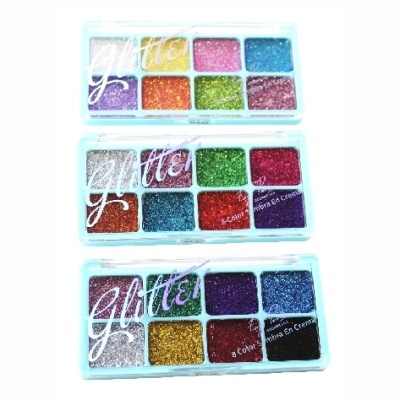 Três paletas de glitter colorido em caixas plásticas transparentes