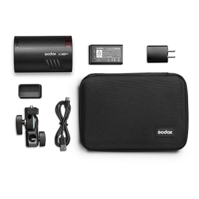 Conjunto Godox com luz LED, bateria, carregador, cabo USB, suporte ajustável e mala preta com logo.