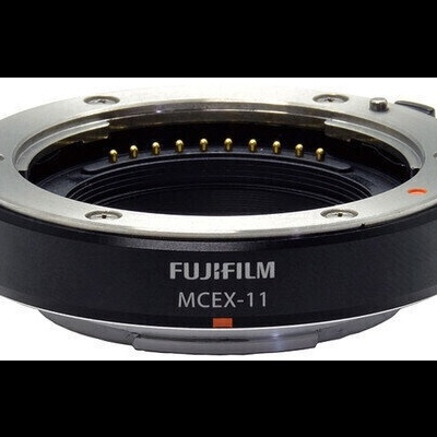 Adaptador de lente Fujifilm MCEX-11 preto com texto branco e marcador laranja
