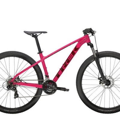 Bicicleta rosa todo-o-terreno com pneus grossos e travões de disco.