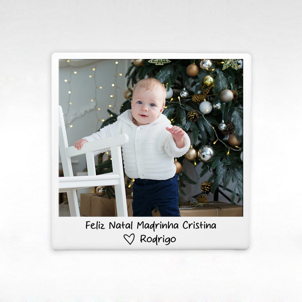 Foto Polaroid de bebé junto a cadeira branca e árvore de Natal decorada