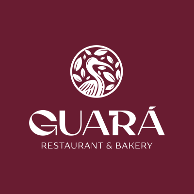 Logotipo do restaurante e padaria Guará com ave e folhas