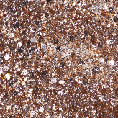 Partículas brilhantes de glitter dourado, prateado e bronze em textura irregular