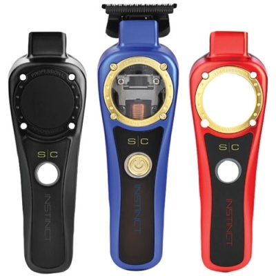 Três máquinas de corte de cabelo INSTINCT em preto, azul e vermelho com detalhes dourados