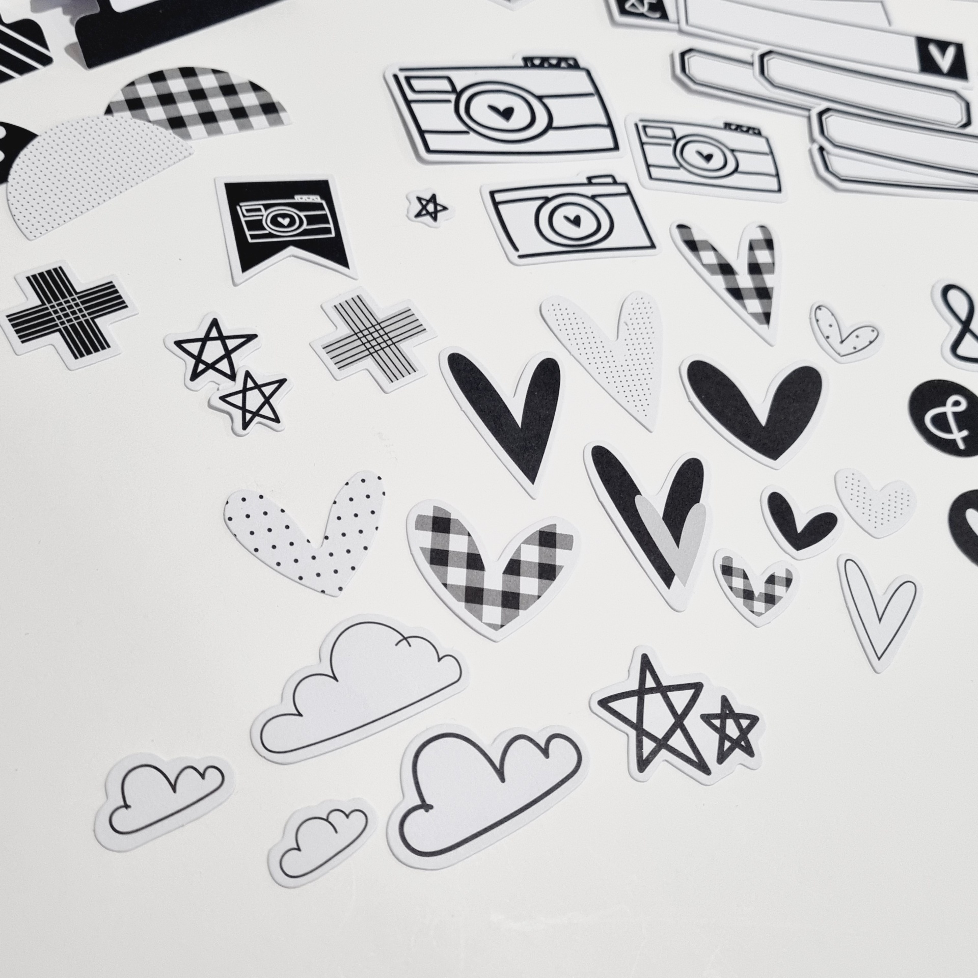 Autocolantes preto e branco com formas diversas sobre fundo branco