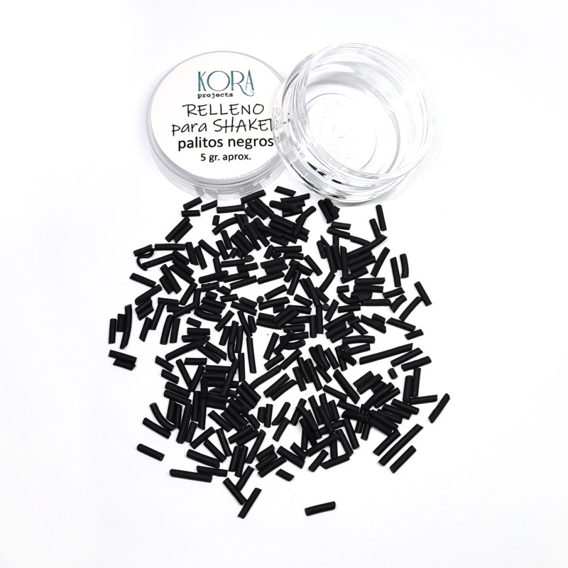 Recipiente transparente com tampa branca e pequenos palitos negros espalhados