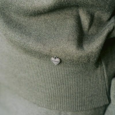 Tecido verde oliva com medalha em forma de coração com inscrição ECRU