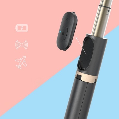 Dispositivo electrónico portátil preto com componente removível num fundo rosa e azul