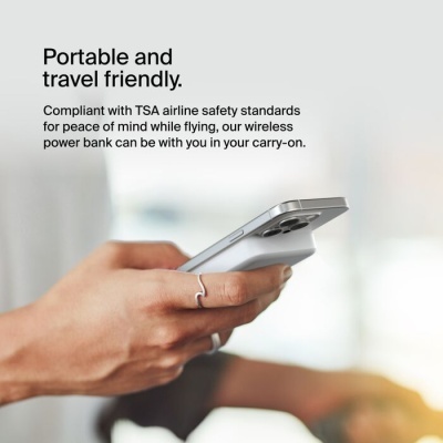 Mão a segurar smartphone cinza claro e uma power bank sem fios branca atrás, texto sobre portabilidade