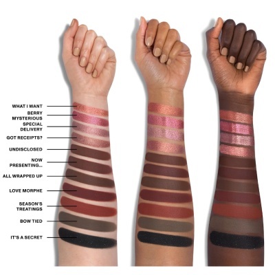 Tres braços com amostras de sombra para olhos em várias cores e nomes ao lado.