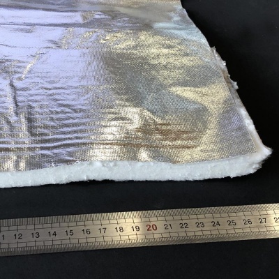 tecido metálico prateado com material felpudo branco e régua metálica em fundo preto