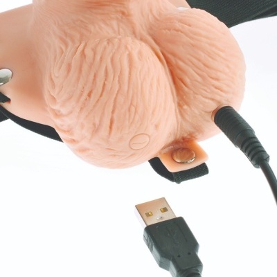 Produto em silicone que simula testículos humanos com cabo USB e correia preta