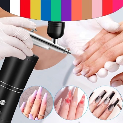 Aerógrafo preto a aplicar em unhas com imagens de unhas decoradas coloridas.