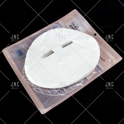 Máscara facial branca sobre embalagem bege claro