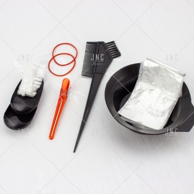 Utensílios para tingimento de cabelo dispostos numa superfície branca