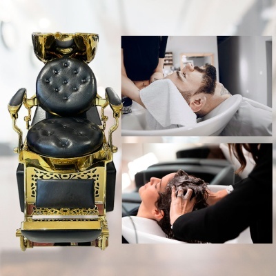 Cadeira de barbeiro dourada em pele preta e lavatórios de salão com clientes a lavar cabelo