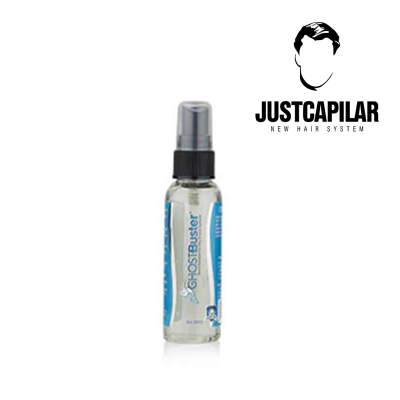 Frasco spray transparente com rótulo azul GHOSTBuster e logótipo JUSTCAPILAR