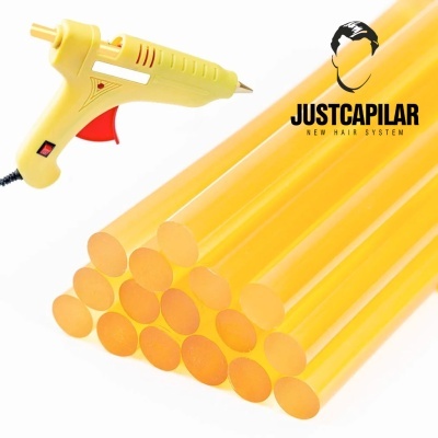 Pistola cola quente amarela com bastões de cola e logotipo JUSTCAPILAR