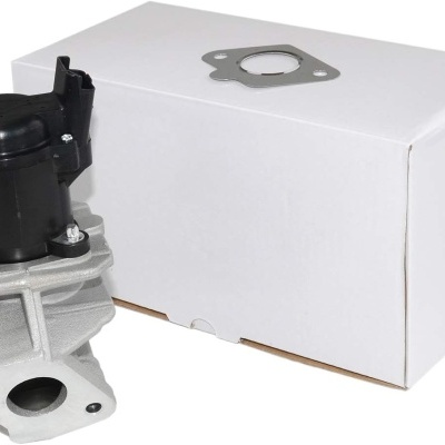 Peça automóvel metálica com parte preta e caixa branca ao lado