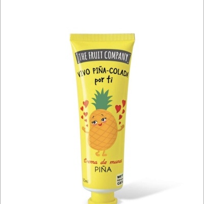 Tubo amarelo com ilustração de ananás e texto em espanhol e inglês.
