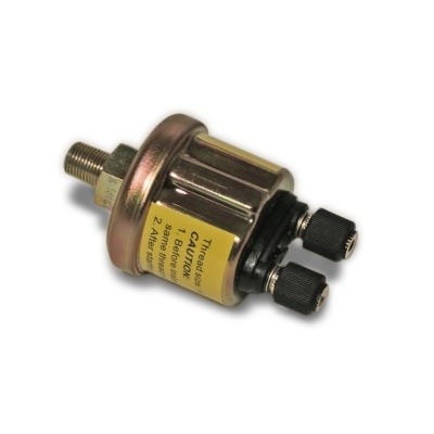 Sensor metálico com etiqueta amarela e duas tampas pretas sobre fundo branco