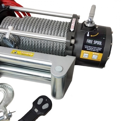 Trator elétrico cinzento com cabo de aço e manípulo preto, etiqueta FREE SPOOL e controlo remoto preto