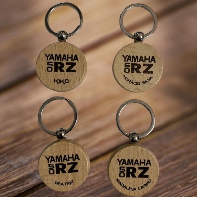 Quatro chaveiros redondos de madeira com argola metálica, com gravações pretas distintas