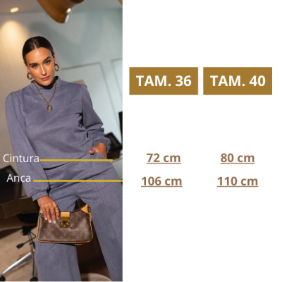 Mulher com fato cinza e mala castanha com padrões e ferragens douradas perto de tabela com medidas de tamanhos 36 e 40.