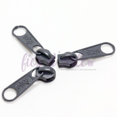 Três puxadores de zíper metálicos pretos sobre fundo branco