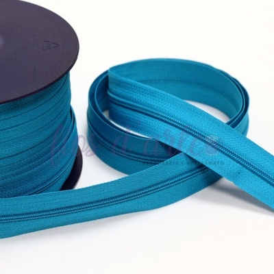 Fecho éclair azul turquesa em rolo e pedaço isolado