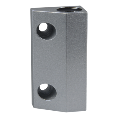 Bloco de metal cinza com três furos circulares, fundo branco