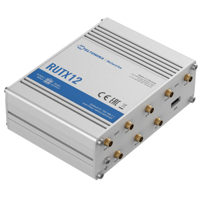 Router industrial metálico Teltonika RUTX12 com várias antenas douradas e inscrições azul e preto