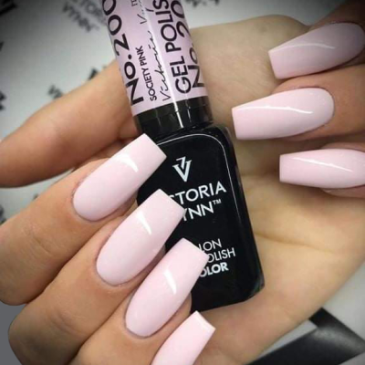 Unhas pintadas rosa claro segurando frasco de verniz gel polish preto Victoria Vynn