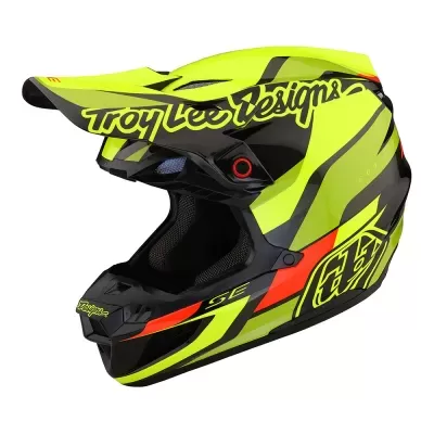 Capacete integral para motocross amarelo neon com texto Troy Lee Designs.