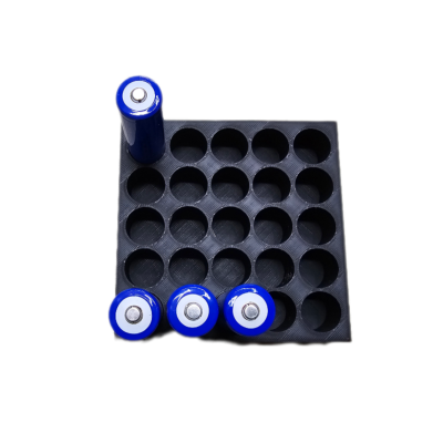 Base quadrada preta com pilhas cylindricas azuis em orifícios circulares