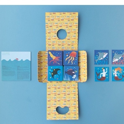 Jogo de cartas oceano com caixa amarela e cartas ilustradas.