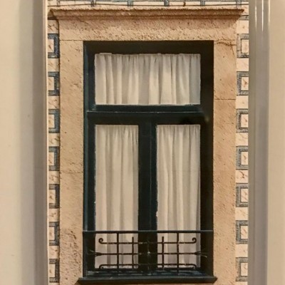 Íman com fotografia de janela tradicional com moldura preta, cortinas brancas e azulejos azuis e brancos