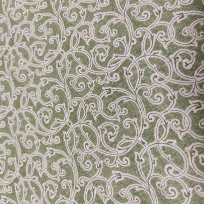 Tecido verde com padrão branco de arabescos decorativos
