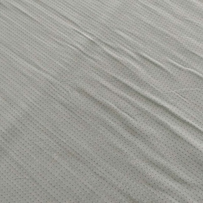 tecido cinzento claro com pequenos buracos uniformes e dobras