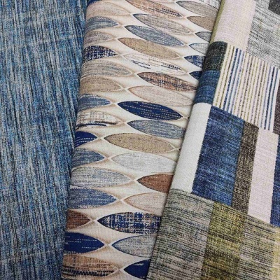 Três tecidos com padrões e cores distintas sobrepostos, incluindo riscas, formas ovais e padrão geométrico.