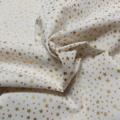 Tecido creme c/estrelas ouro 150cm  NEB01