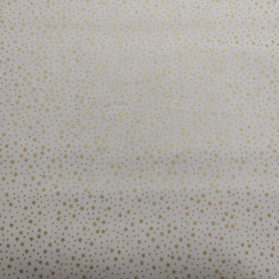 Pano branco com pequenas estrelas douradas em padrão uniforme