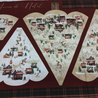 Quadro com padrão natalício de casas e pessoas em tecido sobre fundo vermelho e verde xadrez.