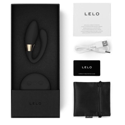 Produto LELO em caixa preta com dispositivo de silicone, cabo USB, cartão de garantia, saco de transporte e manual