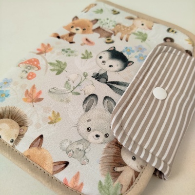 Carteira de tecido com estampado de animais da floresta e aba riscada com botão branco