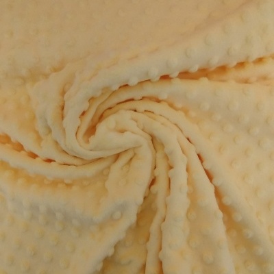 Tecido amarelo claro com pequenos pontos em relevo