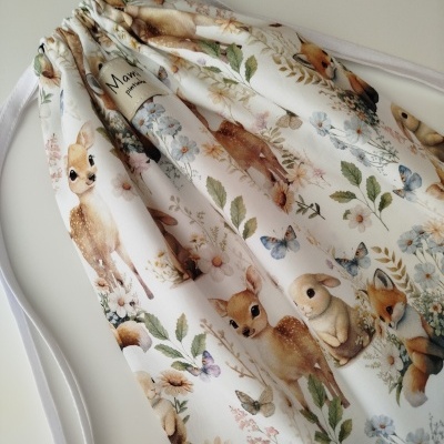 Saco de pano branco com padrão de animais e flores coloridas