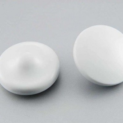 Dois botões brancos redondos com superfície lisa sobre fundo cinza