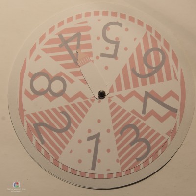 Relógio redondo com padrão geométrico rosa e branco e números cinzentos